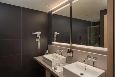 a bathroom with a sink and a mirror at NH Palermo in Palermo