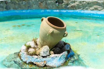 a vase sitting on a rock in the water at Appartamento Ashur Mondello in Palermo