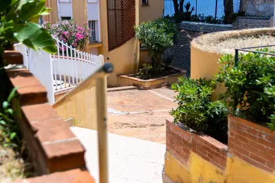 a courtyard of a house with plants and a fence at Appartamento Ashur Mondello in Palermo