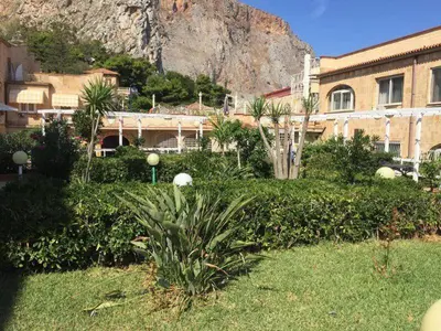 a view of a building with a mountain in the background at Appartamento Ashur Mondello in Palermo