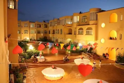 a courtyard of a building with red paper hearts at Appartamento Ashur Mondello in Palermo
