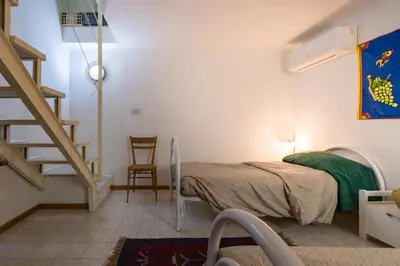 a bedroom with a bed and a staircase in a room at APPALERMO la tua casa ideale per visitare la città in Palermo
