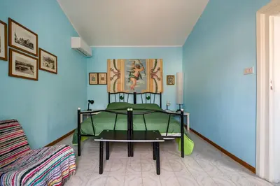 a bedroom with a green bed and a table at APPALERMO la tua casa ideale per visitare la città in Palermo