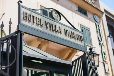 a street sign in front of a building at Hotel Villa d'Amato in Palermo
