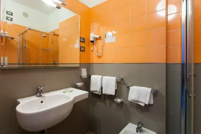 a bathroom with a sink and a mirror at Hotel Villa d'Amato in Palermo