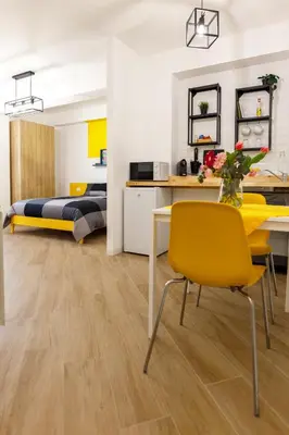 a bedroom with a bed and a table and a yellow chair at TERRAVERA in Terrasini