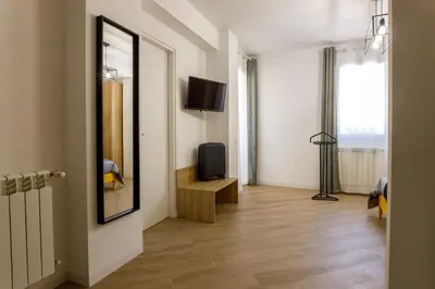 a living room with a television and a mirror at TERRAVERA in Terrasini