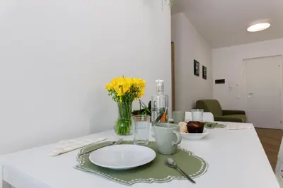 a white table with a plate and flowers on it at TERRAVERA in Terrasini