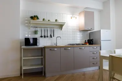 a kitchen with a sink and a refrigerator at TERRAVERA in Terrasini