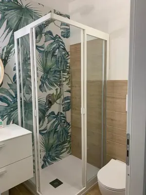 a bathroom with a shower and a toilet at La Casetta Blu al Mulino in San Vito lo Capo