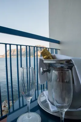 a table with a blender and two glasses on a balcony at Splendid Hotel La Torre in Mondello