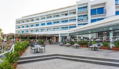 a building with tables and chairs in front of it at Splendid Hotel La Torre in Mondello