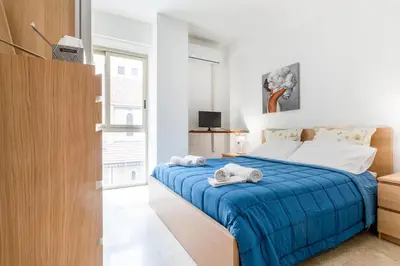 a bedroom with a blue bed with towels on it at GuestHost - Teatro Politeama and Teatro Massimo Cozy Apartment in Palermo