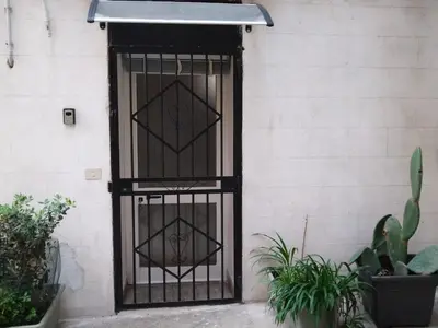 a door with a wrought iron gate on a building at Casa dei Tre Re in Palermo