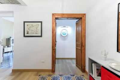 a bathroom with a door leading to a kitchen at Kalbita home in Palermo