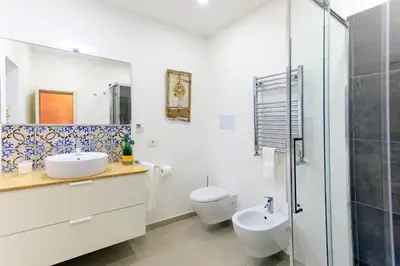 a bathroom with two sinks and a shower at Kalbita home in Palermo