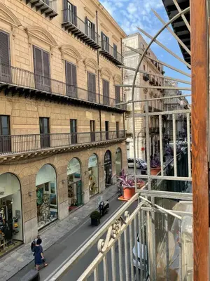 a person riding a skateboard down a city street at Quattro Canti by DomuSicily in Palermo