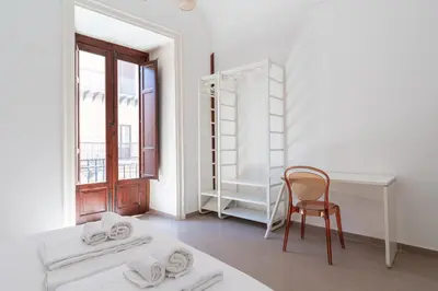 a white room with a desk and a chair at Quattro Canti by DomuSicily in Palermo