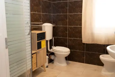 a bathroom with a toilet and a sink at Exclusive in Palermo