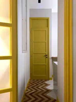a yellow door in a room with a hallway at The347, Diletta in Palermo