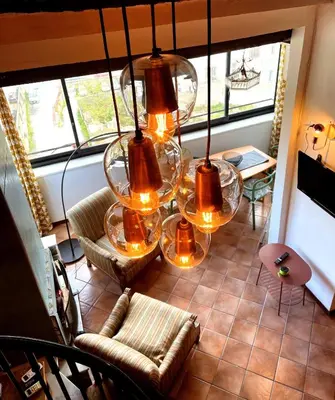 a room with a chandelier and chairs and a couch at Loft Aragonese in Palermo