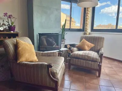 a living room with two chairs and a fireplace at Loft Aragonese in Palermo