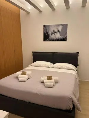 a bedroom with a large bed with towels on it at Lux Apartment in Historical Center of Palermo in Palermo