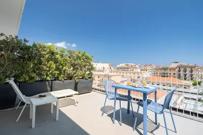 a patio with a table and chairs on a balcony at Suite al centro di Palermo con terrazza privata in Palermo