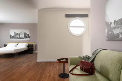 a living room with a couch and a window at Suite al centro di Palermo con terrazza privata in Palermo