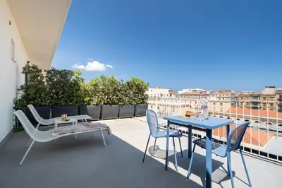 a patio with a table and chairs on a balcony at Suite al centro di Palermo con terrazza privata in Palermo