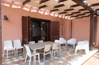 a white table and chairs on a patio at Villa Morici con ampio giardino in San Vito lo Capo