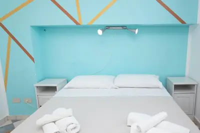a bedroom with a bed with towels on it at Villa Morici con ampio giardino in San Vito lo Capo
