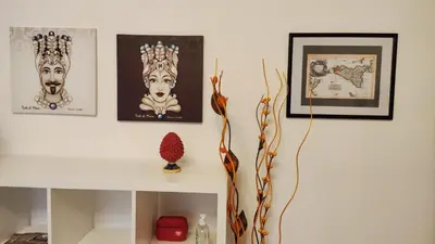 a room with pictures of the crowns on the wall at Amunì rooms and suite LT in Palermo