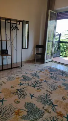 a room with a rug on the floor with a glass door at Amunì rooms and suite LT in Palermo