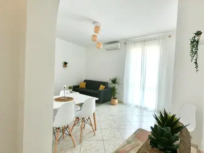 a living room with a table and a couch at La Casetta sul Golfo in Sferracavallo