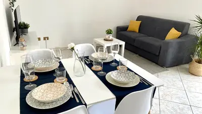 a dining room with a table with plates and wine glasses at La Casetta sul Golfo in Sferracavallo