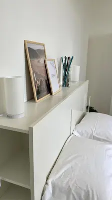 a white desk with two pictures and a bed at La Casetta sul Golfo in Sferracavallo