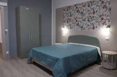 a bedroom with a bed with a quilt on it at Terrazza Solemar -four rooms in Castellammare del Golfo