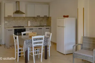 a bathroom with a sink and a shower with a mirror at Terrazza Solemar -four rooms in Castellammare del Golfo