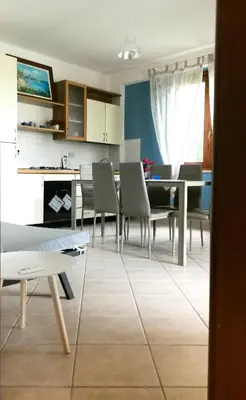 a kitchen and dining room with a table and chairs at L'oasi nello Zingaro in Scopello