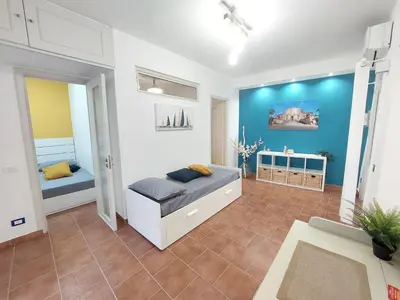 a bedroom with a bed and a blue wall at Guest House Palermo Massimo 23 in Palermo