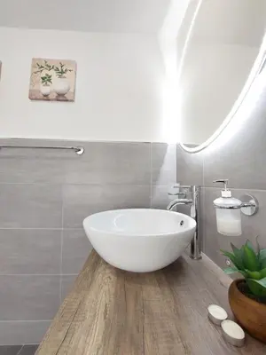 a white bath tub in a bathroom with a sink at Guest House Palermo Massimo 23 in Palermo