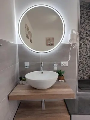 a bathroom with a white sink and a mirror at Guest House Palermo Massimo 23 in Palermo