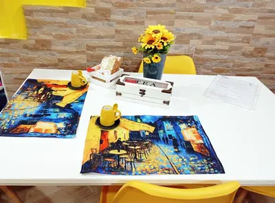 a white table with flowers and a painting on it at Palermo Centro - I Pastelli di Van Gogh in Palermo