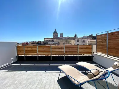 a balcony with two lounge chairs on a roof at B&B ALIVA in Alcamo