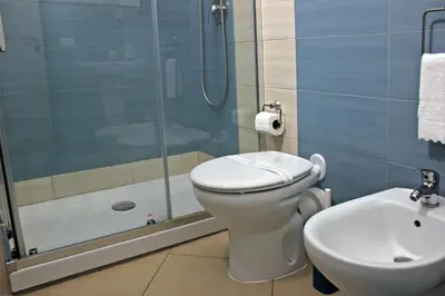 a bathroom with a toilet and a shower and a sink at Antica Palermo in Palermo