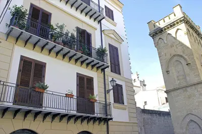 a building with balconies and a clock tower at Antica Palermo in Palermo