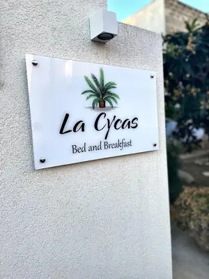 a sign for la gypsy bed and breakfast on a building at B&B La CYCAS in San Vito lo Capo