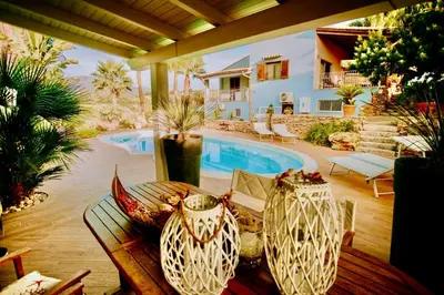 a patio with a table and a swimming pool at Villa Dora con piscina in Trappeto
