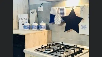 a stove top in a kitchen with a star on the wall at Villa Dora con piscina in Trappeto